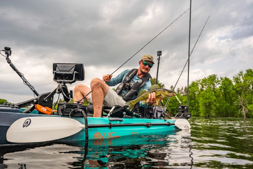 Angler using a jigging rig on a Canadian lake, demonstrating fishing techniques and best practices