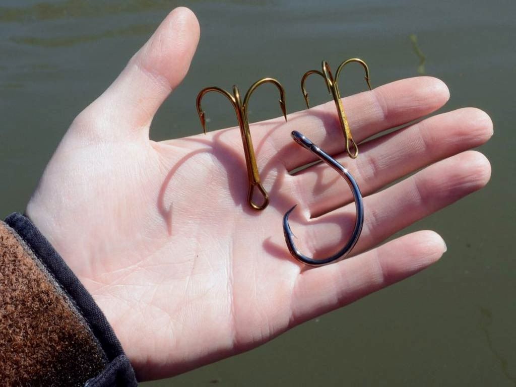 A selection of the top 10 most popular fishing hooks in Canada for 2025, displayed in various shapes and sizes