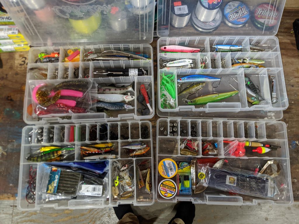 Fisherman organizing hooks and lures in a tackle box for a clean and efficient fishing setup